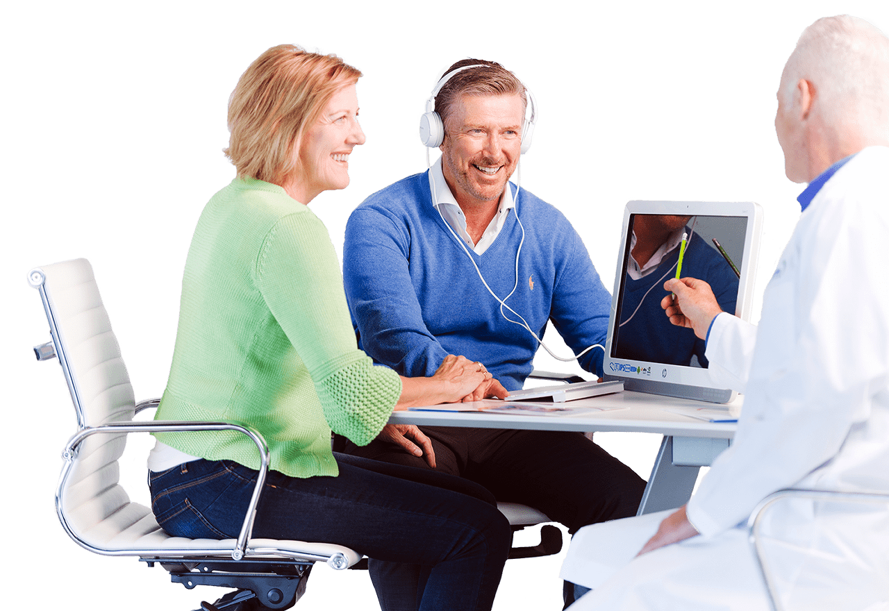 Middle Aged man sitting with his wife while having his hearing tested