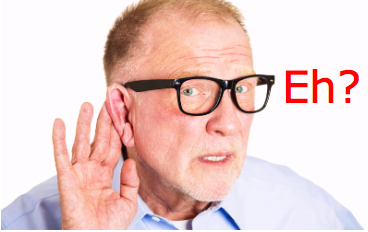 Middle aged man in glasses cupping his hand around his ear to try and hear better.