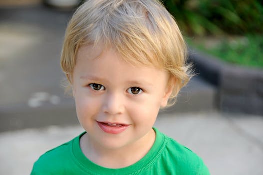 Young boy in a green shirt smiling