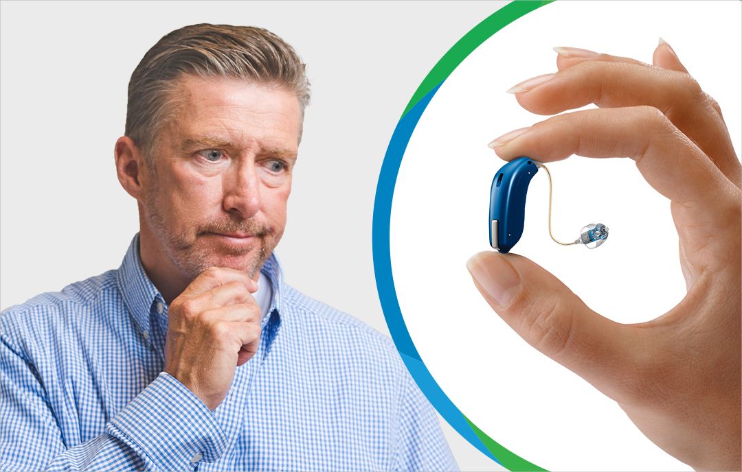 Middle aged man thinking and a behind the ear hearing aid in between a person's thumb and pointer finger