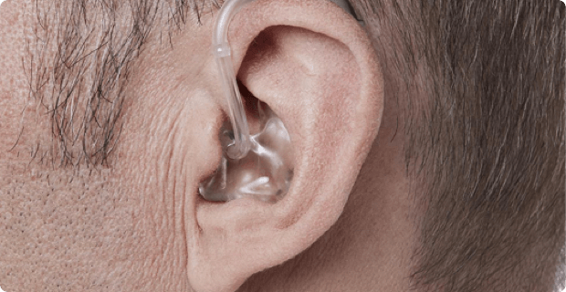 A Man Wearing Behind the Ear Hearing Aid